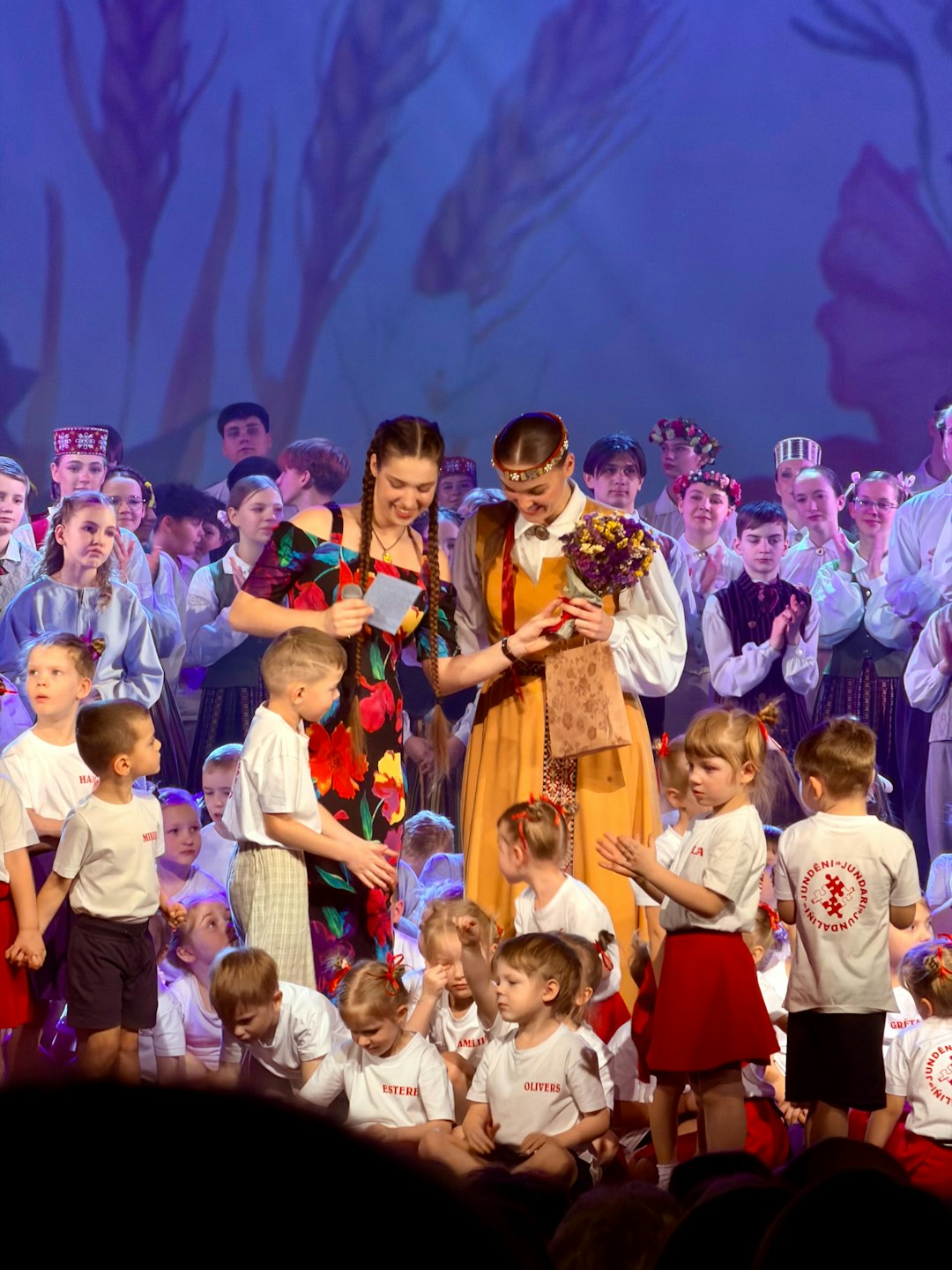 performers-receive-flowers-on-stage-during-a-celebration-pawgffw21di